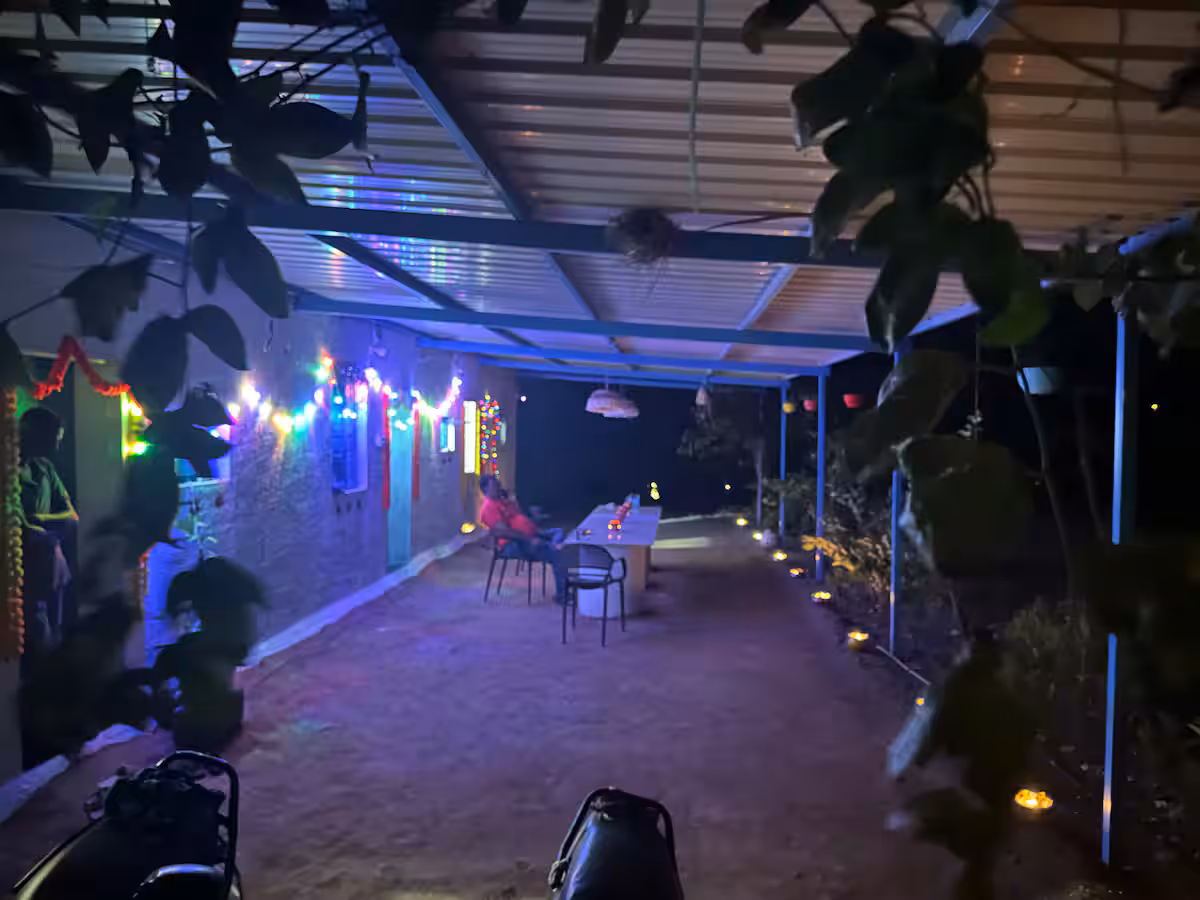 Outdoor dining beneath warm lights